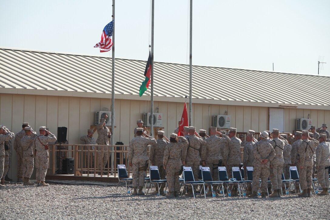 Marines and sailors salute during the morning colors ceremony held at the 1st Marine Logistics Group (Forward) compound on Camp Leatherneck, Afghanistan, July 2. During the ceremony, 1st MLG (Fwd) Marines and sailors celebrated the 65th anniversary of the Logistics Group.