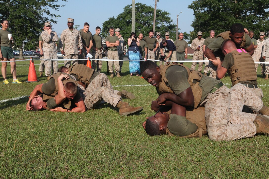 Marines with Headquarters and Support Battalion, grapple during the final event of the HQSPTBn. Commander’s Cup Challenge on the battalion parade field aboard Marine Corps Base Camp Lejeune June 29. Each company brought their best grapplers to ground fight, but in the end it was Company A who won the tournament, making them champions this year and providing them their fourth trophy in the series of 13 sports tournaments held by HQSPTBn.