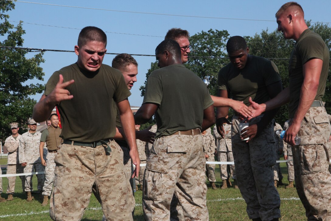 Marines with Company A, Headquarters and Support Battalion, celebrate after seizing the championship during the HQSPTBn. Commander’s Cup Challenge on the battalion parade field aboard Marine Corps Base Camp Lejeune June 29. The grappling tournament was the last of a series of 13 sports tournaments held by HQSPTBn.