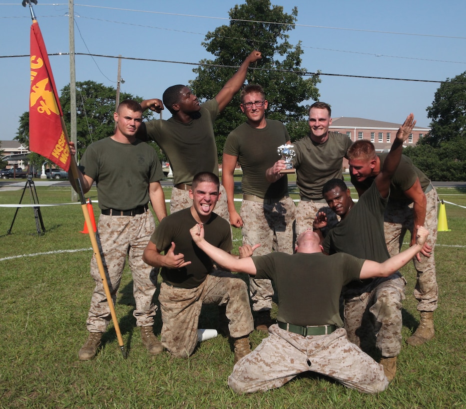 Marines with Company A, Headquarters and Support Battalion, pose for a group photo after seizing the championship during the HQSPTBn. Commander’s Cup Challenge on the battalion parade field aboard Marine Corps Base Camp Lejeune June 29. The grappling tournament was the last of a series of 13 sports tournaments held by HQSPTBn.