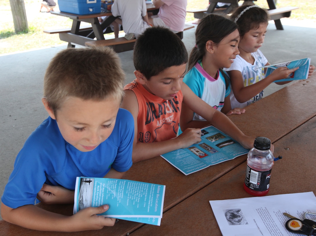 Children read about animals during Onslow Beach’s Expedition Mammals and Animals of North Carolina event hosted at the Onslow Beach Osprey Pavilion aboard Marine Corps Base Camp Lejeune June 20. More than 40 people arrived for the event. 