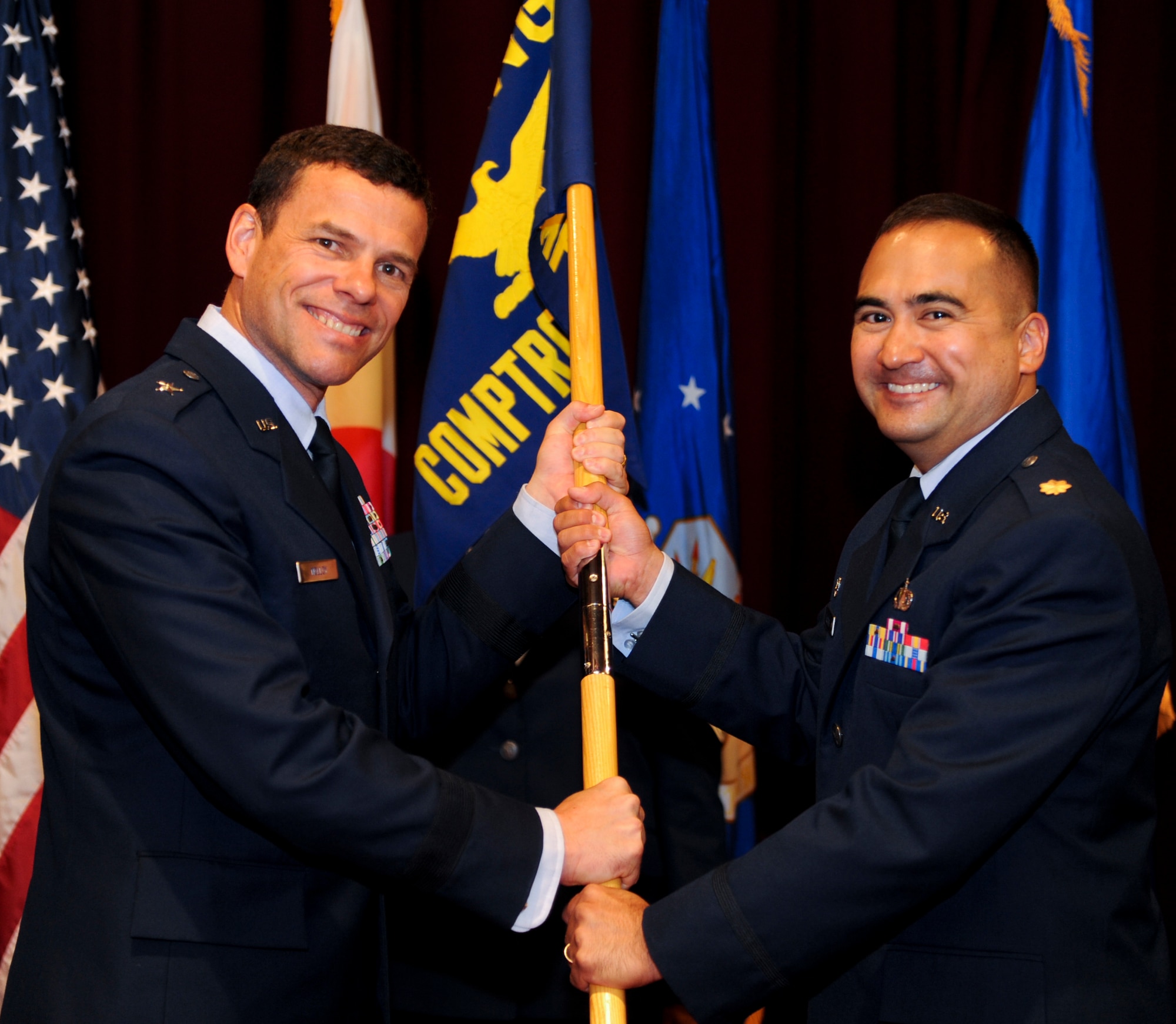 U.S. Air Force Maj. Daniel McCrary, newly appointed commander of the 18th Comptroller Squadron, accepts the guidon from Brig. Gen. Matthew Molloy, 18th Wing commander, during a change of command ceremony on Kadena Air Base, Japan, June 3, 2012. McCrary comes from Hill Air Force Base, Utah, where he served as 75th Comptroller Squadron commander. (U.S. Air Force photo/Airman 1st Class Justin Veazie)