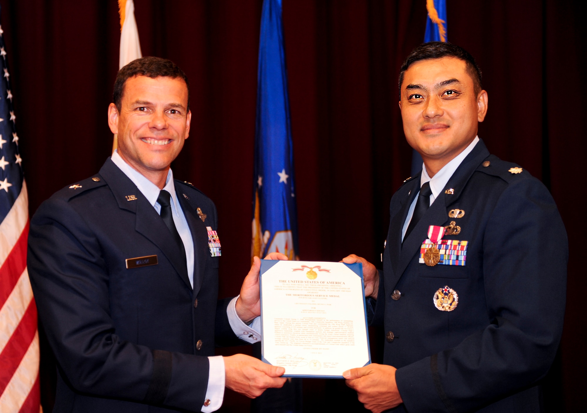 U.S. Air Force Lt. Col. Seung Paik, former commander of the 18th Comptroller Squadron, receives the Meritorious Service Medal from Brig. Gen. Matthew Molloy, 18th Wing commander, during a change of command ceremony on Kadena Air Base, Japan, June 3, 2012. The Meritorious Service Medal is a military decoration presented to members of the United States Armed Forces who distinguished themselves by outstanding meritorious achievement or service to the United States.  (U.S. Air Force photo/Airman 1st Class Justin Veazie)