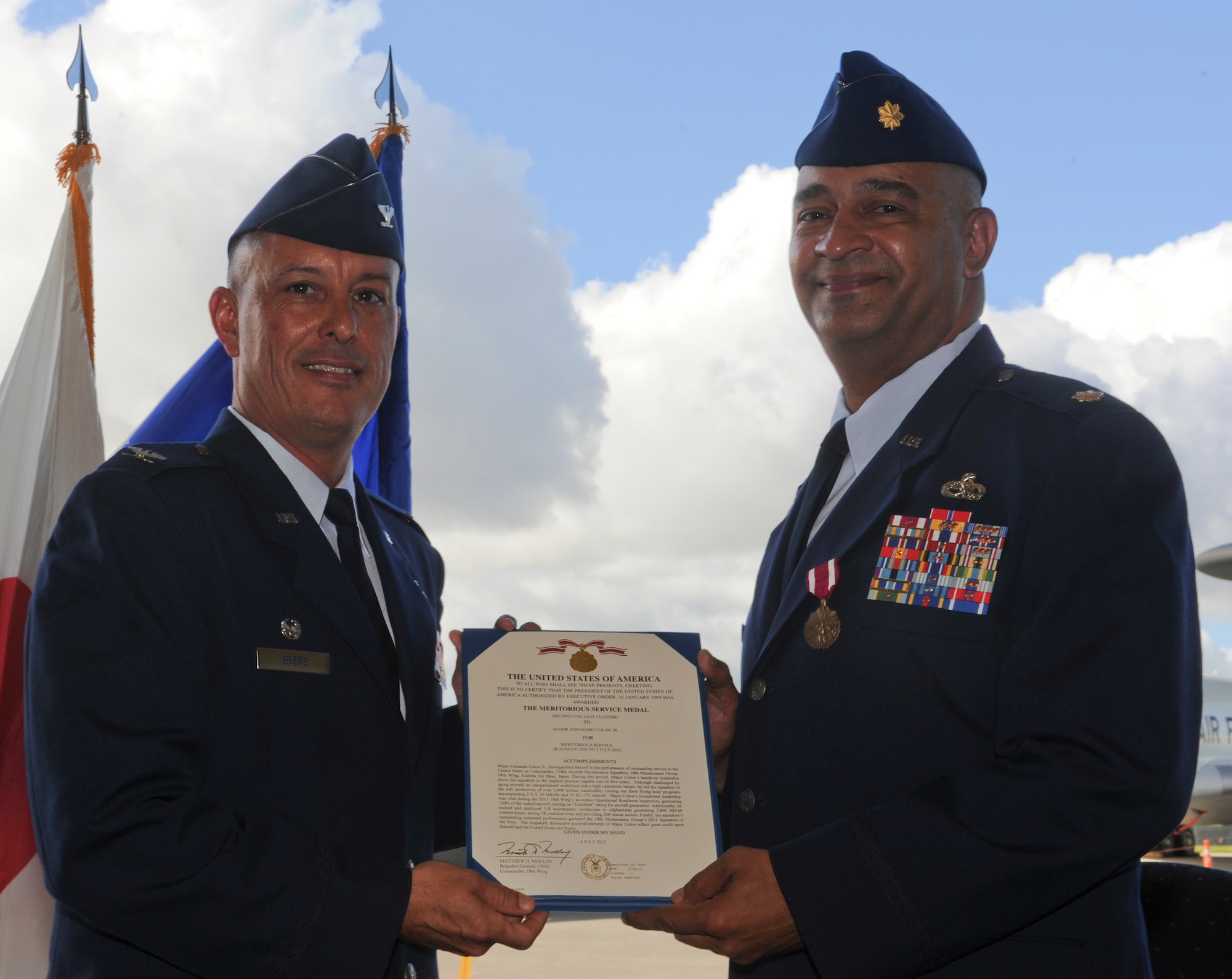 U.S. Air Force Maj. Fernando Colon Jr., former commander of the 718th Aircraft Maintenance Squadron, receives the Meritorious Service Medal from Col. Brian Beers, 18th Maintenance Group commander, during a change of command ceremony on Kadena Air Base, Japan, June 3, 2012. The Meritorious Service Medal is a military decoration presented to members of the United States Armed Forces who distinguished themselves by outstanding meritorious achievement or service to the United States. (U.S. Air Force photo/Airman 1st Class Justin Veazie)