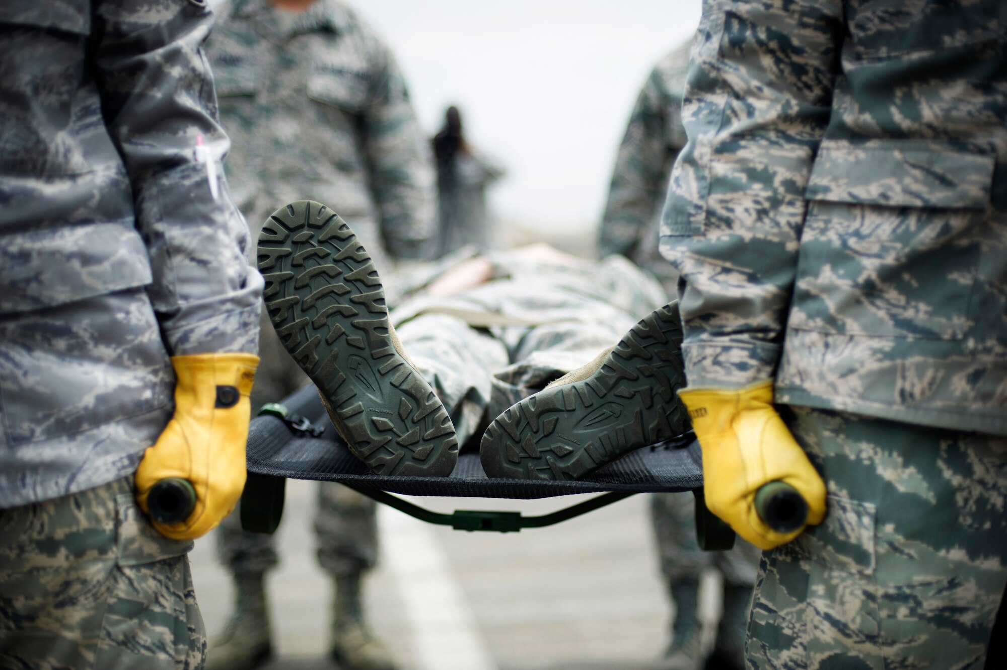YOKOTA AIR BASE, Japan -- Tech. Sgt. Joseph Mooney, a member of the 374th
Medical Operations Squadron, is carried on a litter during a simulated
medical evacuation exercise at Yokota Air Base, Japan, July, 29, 2012.
During the exercise, Mooney was loaded onto a helicopter the purpose was to do live on loading and off loading of patients under the rotors, and to experience the in-flight environment to perform patient care. (U.S. Air Force photo by Staff Sgt. Stacy Moless)
