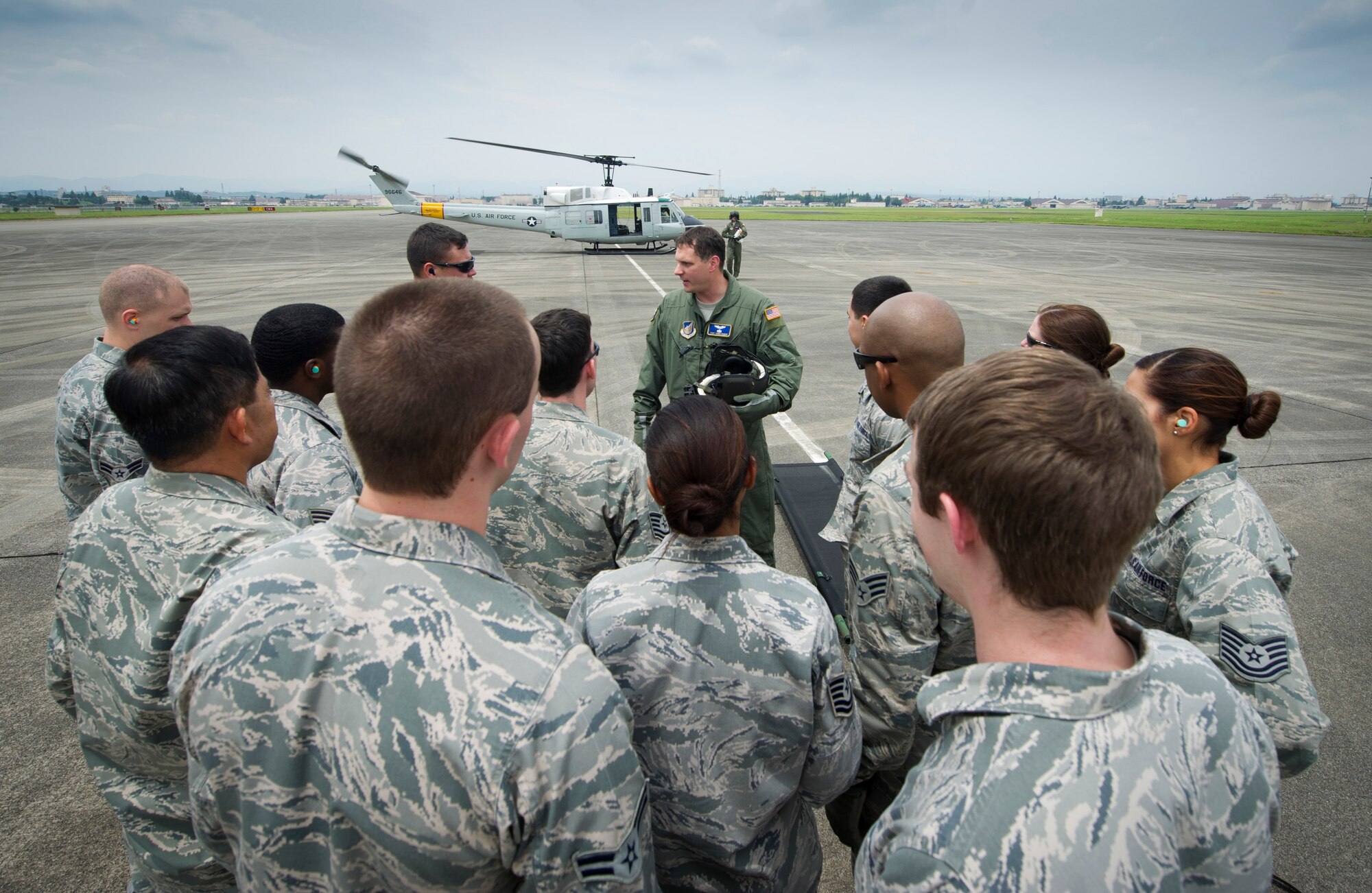 YOKOTA AIR BASE, Japan -- Tech. Sgt. Christopher Baker, 459th Airlift Squadron flight engineer, briefs Airmen from the 374th Medical Operations Squadron on safety procedures around the helicopter during a simulated medical evacuation exercise at Yokota Air Base, Japan, July, 29, 2012. Medical personnel practiced loading patients on to litters, litter carrying procedures, and loading them onto a helicopter. (U.S. Air Force photo by Staff Sgt. Stacy Moless)