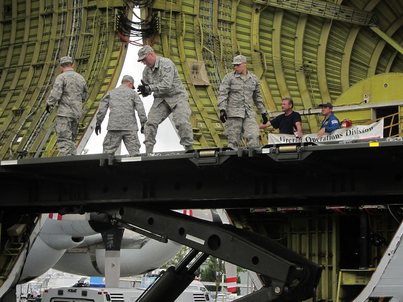 Members of the 62nd Aerial Port Squadron from Joint Base Lewis-McChord, Wash., prepare the Tunner cargo loader before downloading the crew compartment of NASA’s full Fuselage trainer at Boeing Field June 30, 2012. A five-member team from the 62nd APS assisted in the first of three shipments of parts for the trainer that will be housed at the Museum of Flight in Seattle. (Courtesy photo)
