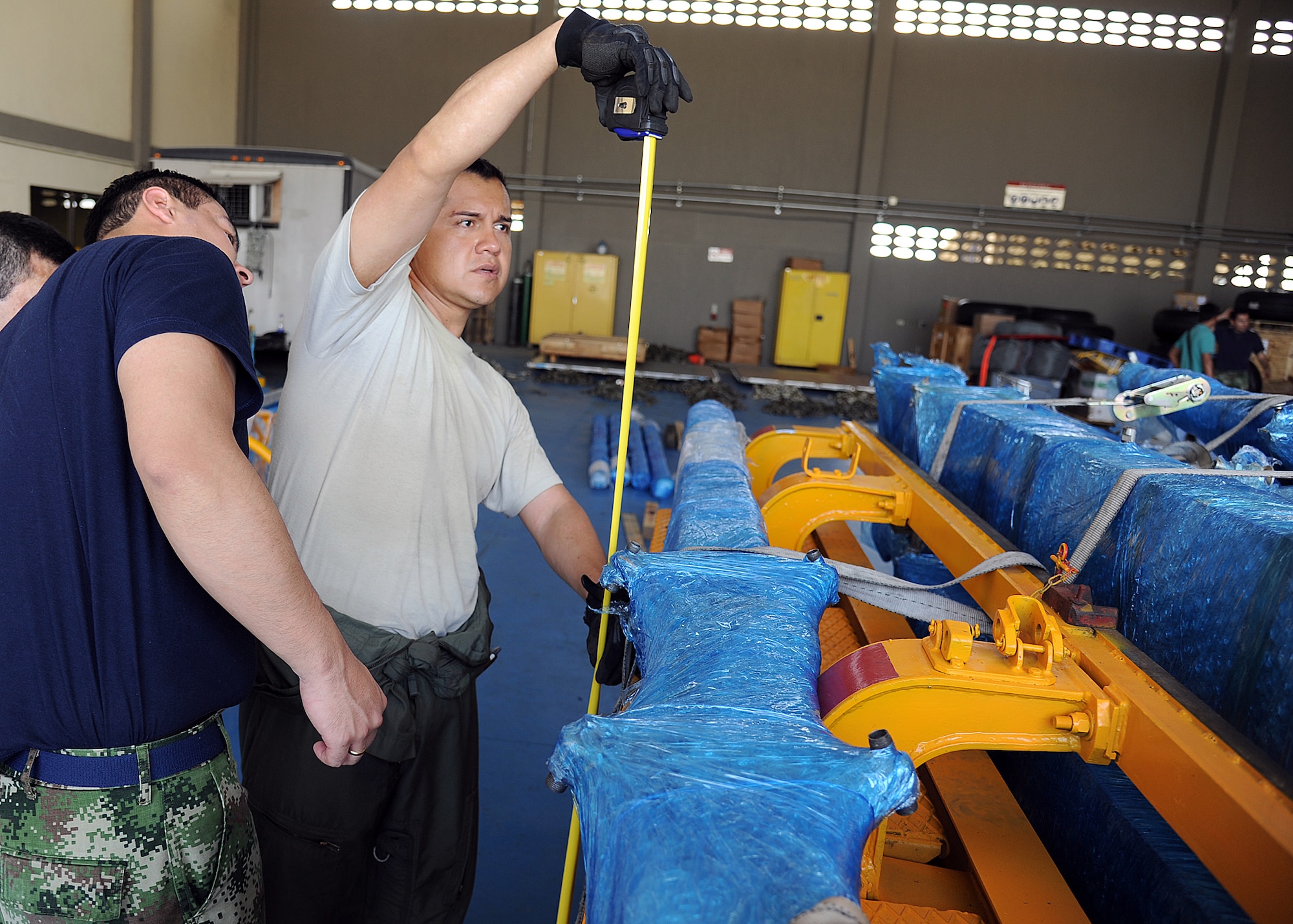 Staff Sgt. Javier Borges (right), 571st Mobility Support Advisory Squadron loadmaster air advisor, and members of the Colombian air force take measurements on a generator for loading onto aircraft during an Air Mobility Command Building Partner Capacity mission at General Alberto Pauwels Rodriguez Air Base in Barranquilla, Colombia, June 27.  (U.S. Air Force photo by Tech. Sgt. Lesley Waters)