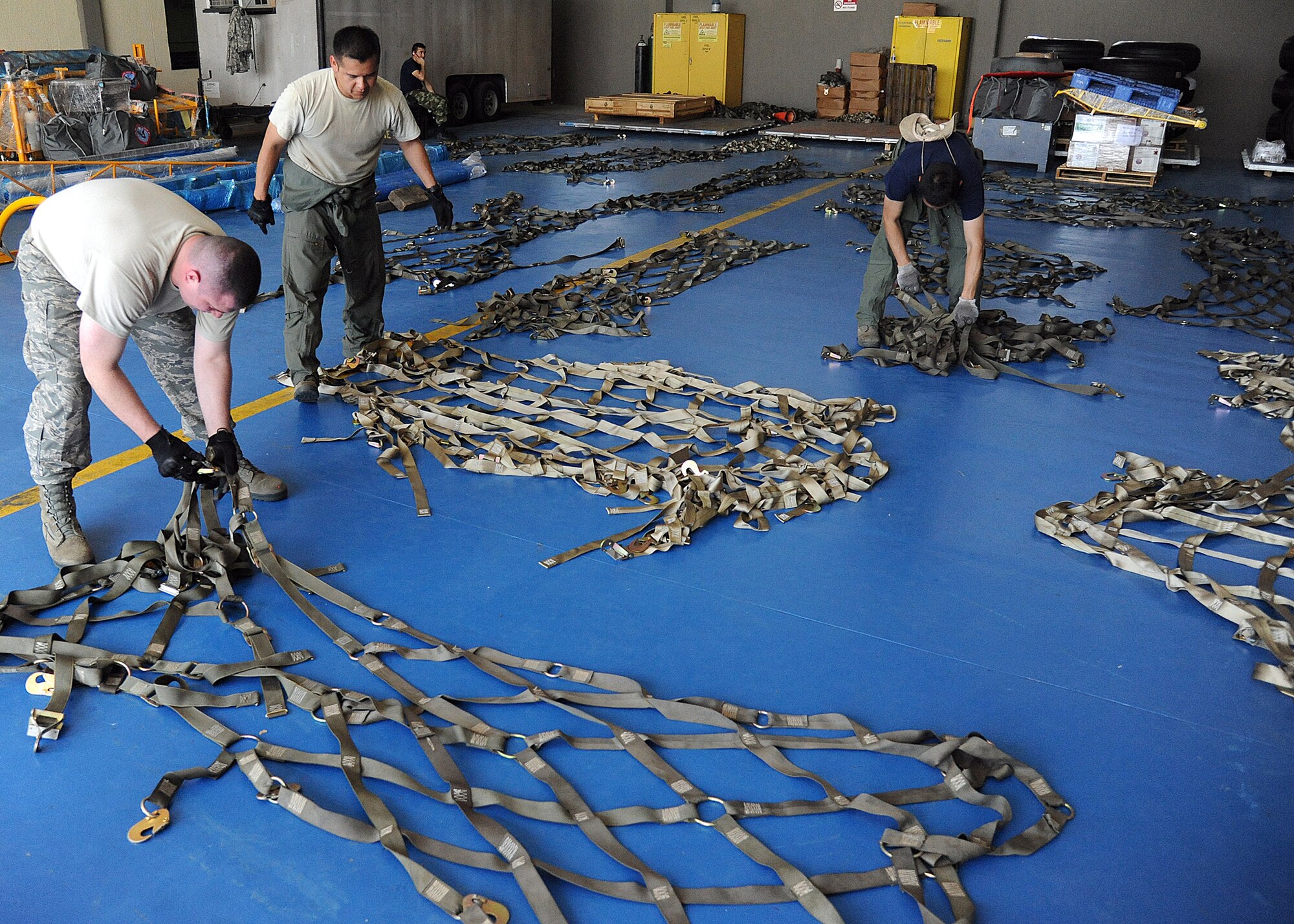 Members of the 571st Mobility Support Advisory Squadron and the Colombian air force, do an inventory and a side and top net inspection during an Air Mobility Command Building Partner Capacity mission at General Alberto Pauwels Rodriguez Air Base in Barranquilla, Colombia, June 27.  (U.S. Air Force photo by Tech. Sgt. Lesley Waters)