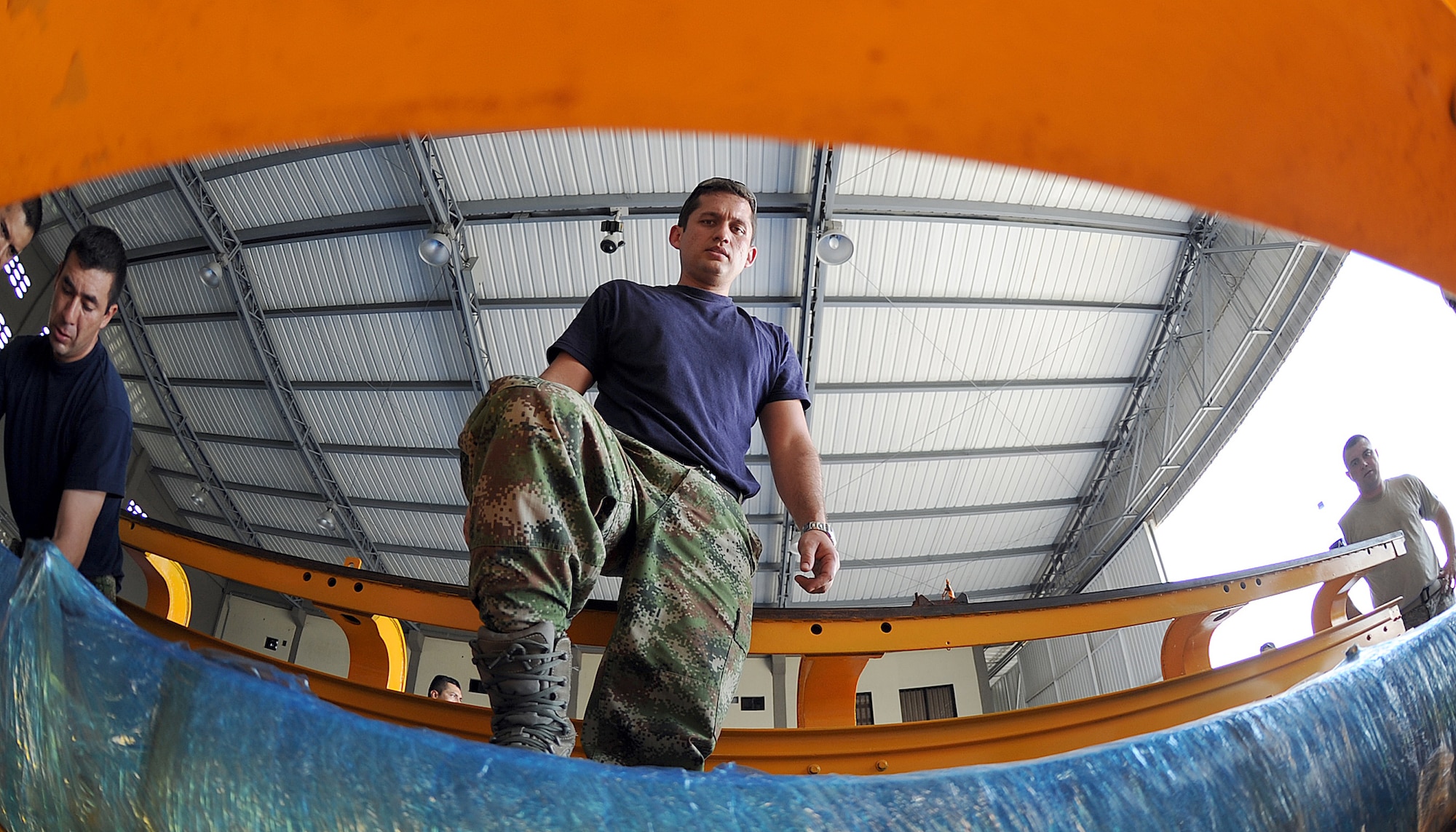 A member of the Colombian air force secures loose equipment before loading it onto an aircraft during an Air Mobility Command Building Partner Capacity mission at General Alberto Pauwels Rodriguez Air Base in Barranquilla, Colombia, June 27.  (U.S. Air Force photo by Tech. Sgt. Lesley Waters)