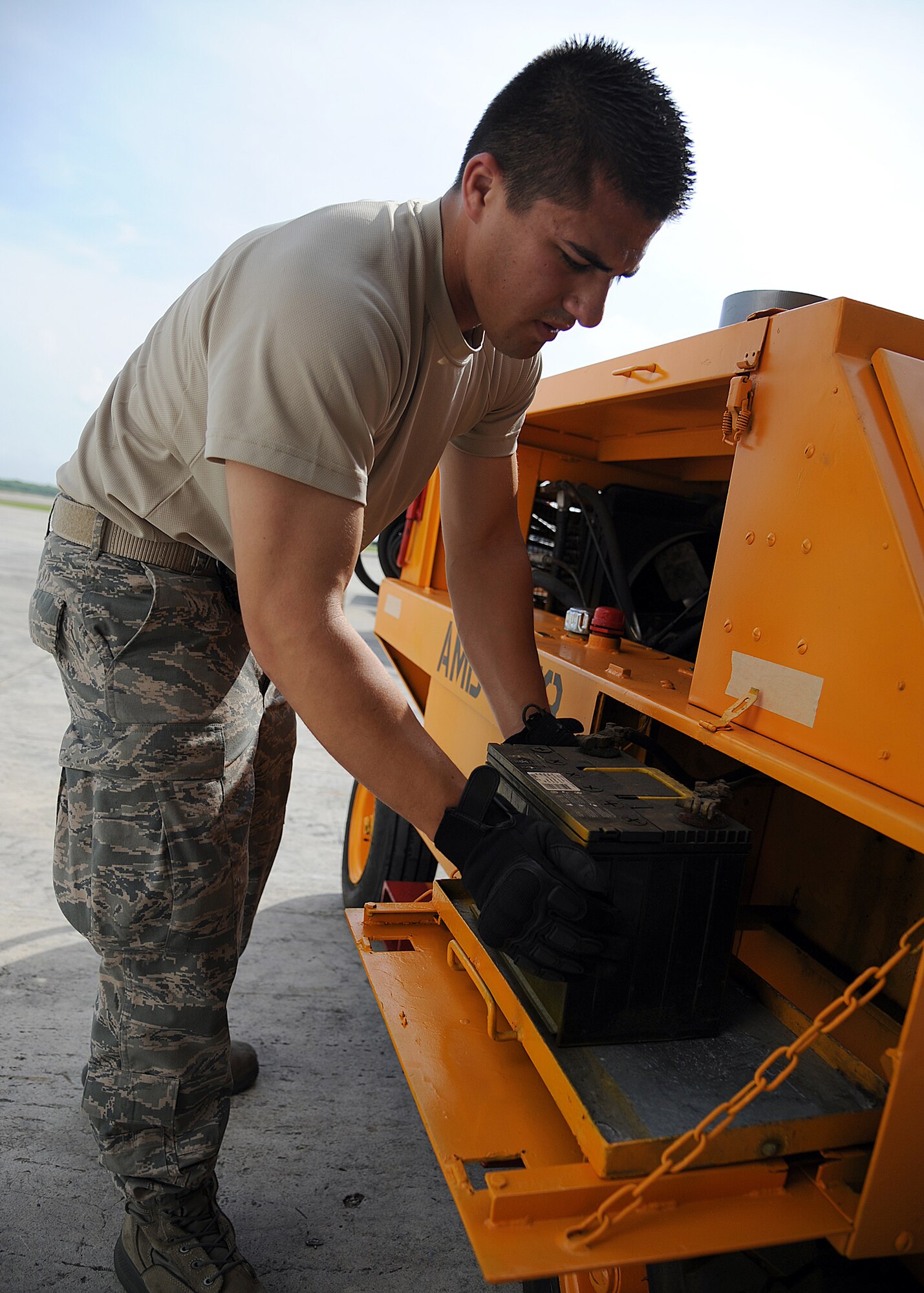 Staff Sgt. Peter Salinas, 571st Mobility Support Advisory Squadron aerial transportation air advisor, checks the battery connections on a generator before weighing and loading it onto an aircraft during an Air Mobility Command Building Partner Capacity mission at General Alberto Pauwels Rodriguez Air Base in Barranquilla, Colombia, June 27.  (U.S. Air Force photo by Tech. Sgt. Lesley Waters)