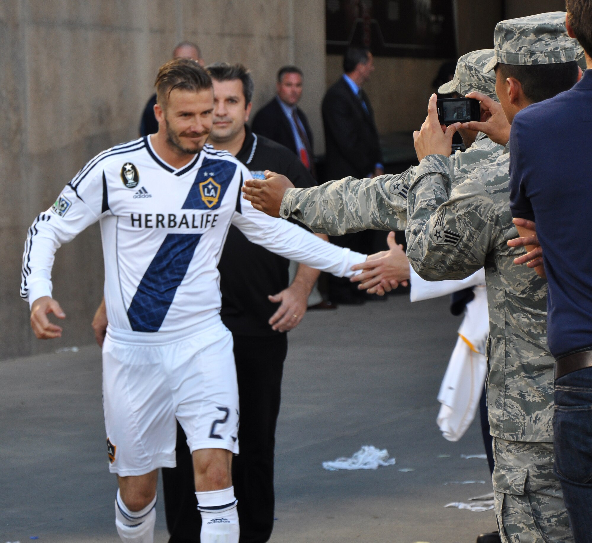 David Beckham, L.A. Galaxy midfielder, shakes the hands of U.S. servicemembers during the start of the second half of the L.A. Galaxy versus San Jose Earthquakes soccer game at Stanford Stadium, Stanford, Calif., June 30, 2012. More than 300 servicemembers participated in a halftime show that honored America’s troops. (U.S. Air Force photo by Staff Sgt. Robert M. Trujillo/Released)