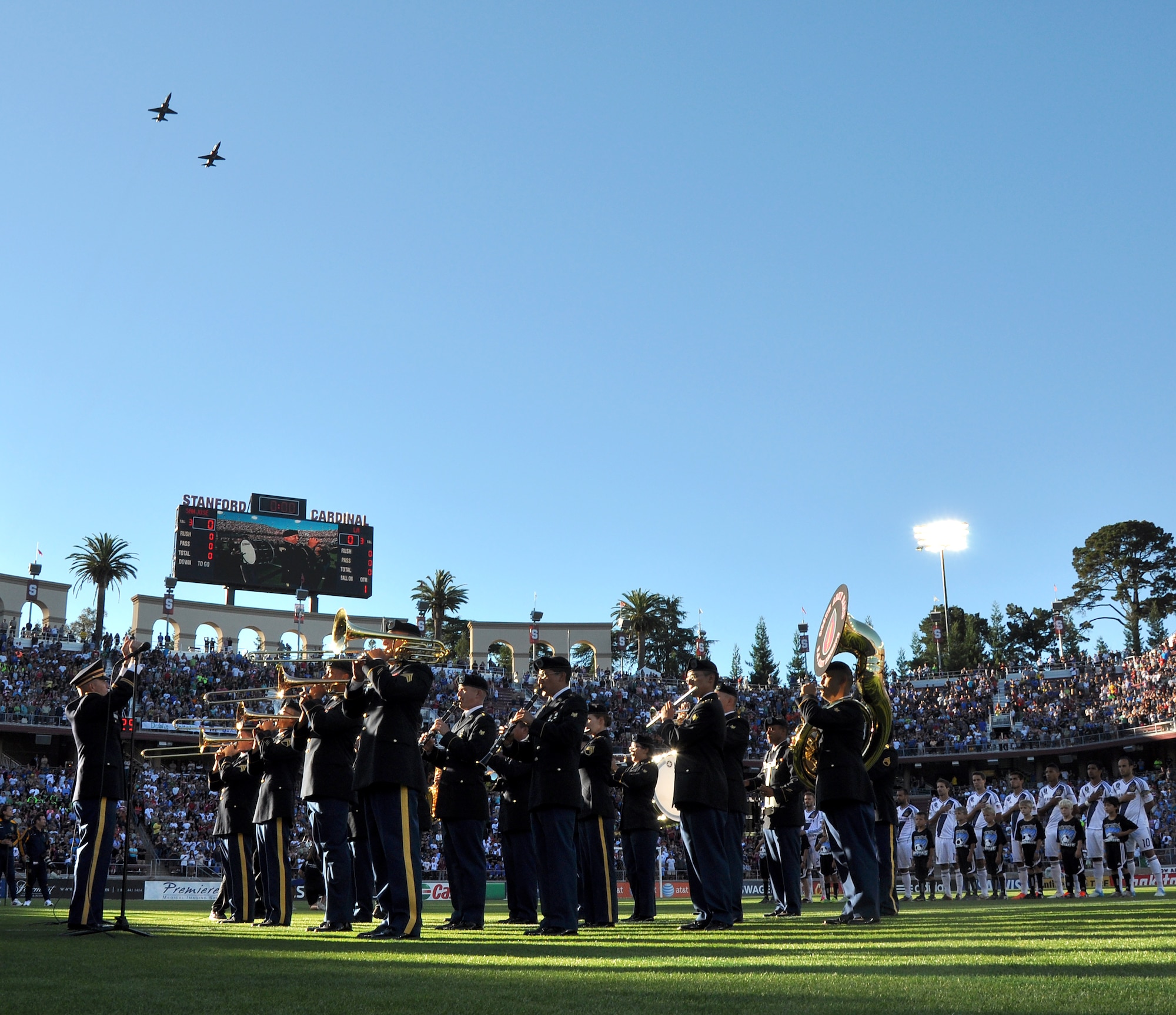 The 300th U.S. Army Reserve Band plays the national anthem as U.S. Air Force T-38 trainer jets fly-over the opening ceremonies of the L.A. Galaxy versus San Jose Earthquakes game at Stanford Stadium, Stanford, Calif., June 30, 2012. The Air Force jets flew from Beale Air Force Base, Calif., to provide the fly-over. (U.S. Air Force photo by Staff Sgt. Robert M. Trujillo/Released)