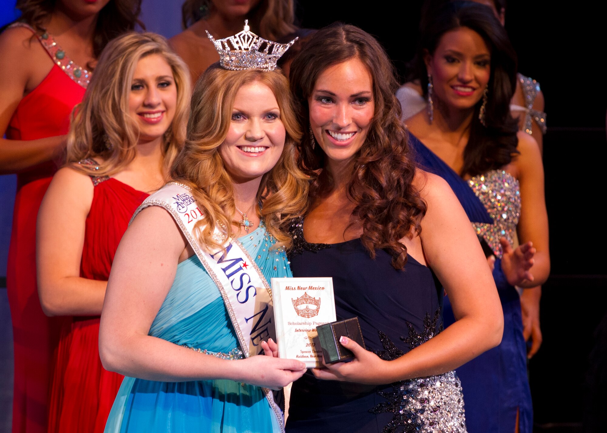 Sarina Turnbull, Miss New Mexico 2011, presents an award to 1st Lt. Chelsey Reams, 49th Logistics Readiness Squadron officer in-charge of plans and integration, for Non-Finalist: Best Interview at the Spencer Theater in Ruidoso, N.M., June 23. After winning the title of Miss Octoberfest in Cloudcroft, N.M., Reams continued on to try out for the Miss New Mexico pageant. (U.S. Air Force photo by Airman 1st Class Michael Shoemaker/Released)