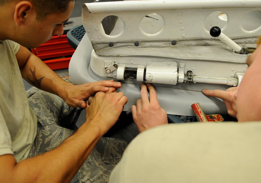 Airman 1st Class Miles Kay and Airman 1st Class Jeston Jump, 2nd Maintenance Squadron repair and reclamation journeymen, replace the main entry hatch seal from a B-52H Stratofortress on Barksdale Air Force Base, La., July 2. Kay and Jump replaced the worn seal to keep air and moisture from entering the aircraft. (U.S. Air Force photo/Airman 1st Class Joseph A. Pagán Jr.)(RELEASED)