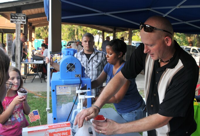 Master Sgt. Scott Kapanke, 437th Maintenance Squadron Accessories Flight flight chief, prepares a snow cone for a customer June 29 during the 2012 Freedom Fest at Marrington Plantation at Joint Base Charleston – Weapons Station. Nearly 1,500 Sailors, Airmen, civilians and their families attended the fest which included food, drinks, festival rides, music and fireworks. (U.S. Air Force photo/Airman 1st Class Jared Trimarchi)