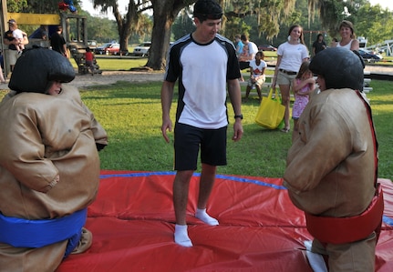 Michael Felton Jr. (right) stares down his opponent and friend Chase Iseman (left) before a sumo suit battle June 29 during the 2012 Freedom Fest at Marrington Plantation at Joint Base Charleston – Weapons Station. Felton is the son of retired Senior Chief Michael Felton Sr. Nearly 1,500 Sailors, Airmen, civilians and their families attended the fest which included food, drinks, festival rides, music and fireworks. (U.S. Air Force photo/Airman 1st Class Jared Trimarchi)