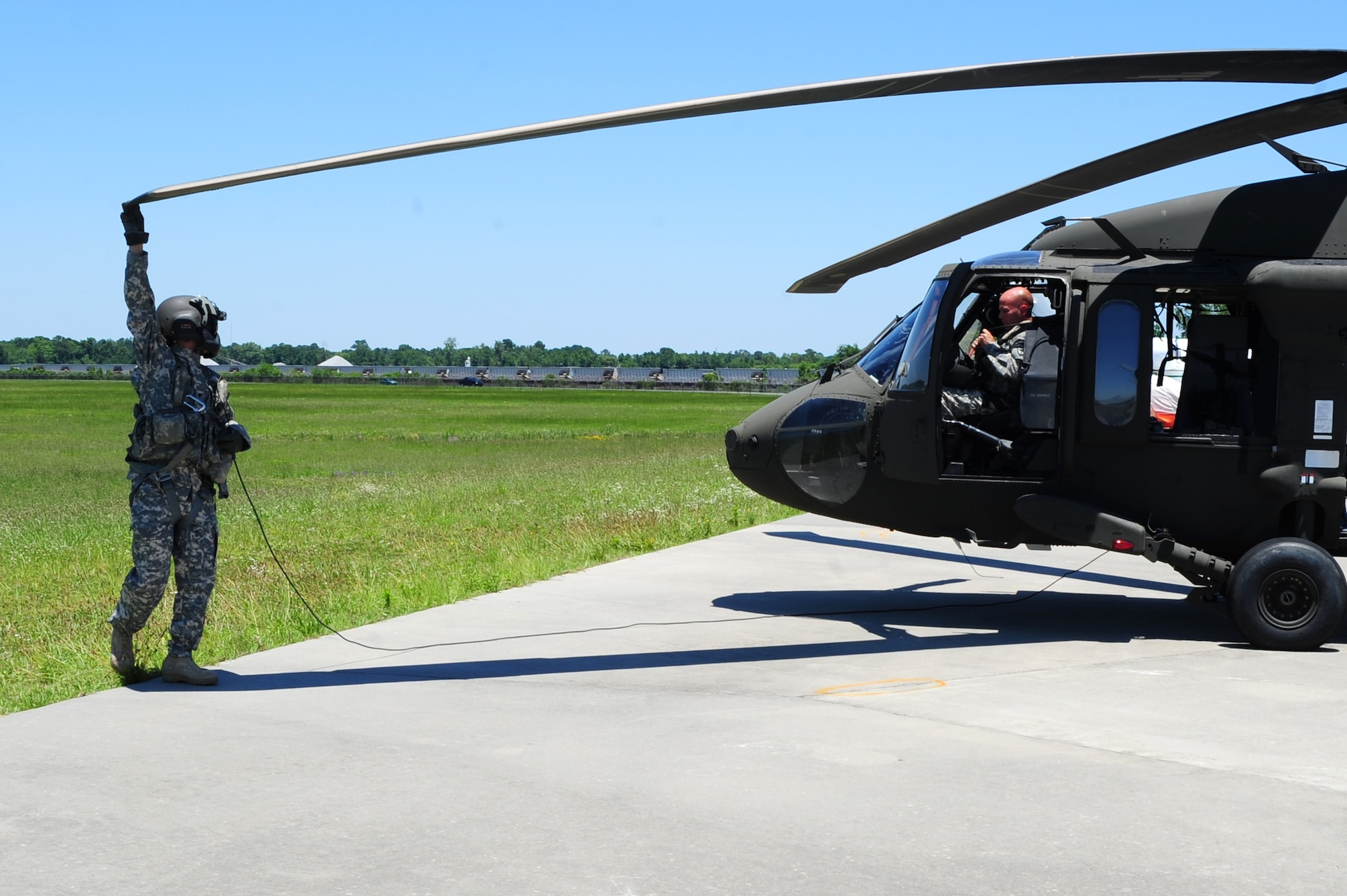 Army Spc. Kenneth Burton, a UH-60 Blackhawk crew chief, 1st Battalion, 151st Aviation Regiment, 59th Aviation Troop Command, Columbia, S.C., performs a maintenance check on a UH-60 Black Hawk before take-off at Atlantic Aviation flight-line, North Charleston, S.C., June 27, 2012.  Maj. Gen. Timothy Byers, the Civil Engineer, Headquarters Air Force, Washington D.C., and Brig. Gen. Timothy Green, Director of Installations and Mission Support, Headquarters Air Mobility Command, Scott Air Force Base, Ill., were given an aerial tour of Joint Base Charleston - Air Base and Weapons Station, Short Stay Naval recreation area and North Auxiliary Air Field.  Byers and Green were accompanied by members of JB Charleston leadership.  (U.S. Air Force/Staff Sgt. Nicole Mickle)  