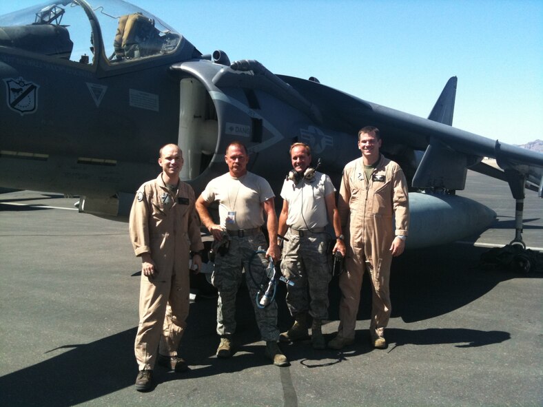 (In the middle, left to right) Tech. Sgt. Dean Adams, 161st Maintenance Group crew chief, and Tech. Sgt. Patrick Jones, 161st Maintenance Group engine mechanic, service the generators on a Marine AV-8 Harrier jet from VMA-214, Yuma, AZ at the 161st Air Refueling Wing, Phoenix, July 22, 2011. This jet broke in Phoenix and was scheduled to be fixed by an outside agency, but because these two Copperheads volunteered their time and skills, the jet was repaired and the mission continued, saving time and money. (Courtesy Photo)