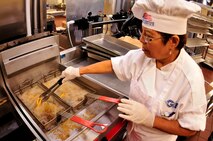 Pavana Carson, a civilian cook with 919th Force Support Squadron, fries onion rings for the lunch meal inside the dining facility at Duke Field, Fla. The civilian staff plays a key role in the monthly support of the dining facility and helped the unit win its seventh Hennessy Trophy since 2000. The Hennessy Trophy is an annual award presented to Air Force installations with the best food-service programs. (U.S. Air Force photo/Tech. Sgt. Cheryl Foster)