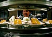 Kyong Lebel, a civilian with 919th Force Support Squadron, sets out the desserts for the lunch meal inside the dining facility at Duke Field, Fla. The civilian staff plays a key role in the monthly support of the dining facility and helped the unit win its seventh Hennessy Trophy since 2000. The Hennessy Trophy is an annual award presented to Air Force installations with the best food-service programs. (U.S. Air Force photo/Tech. Sgt. Cheryl Foster)