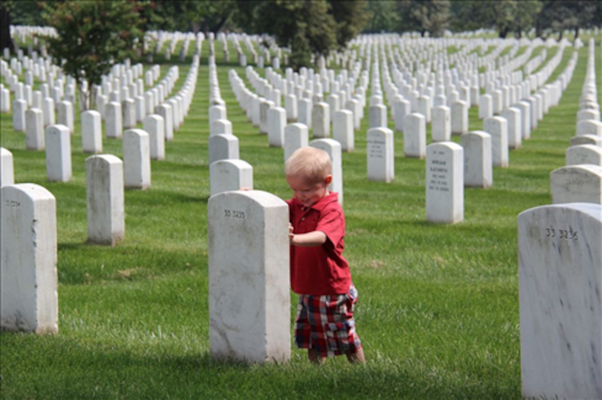 This time of the year, thousands of visitors come from around the world to Arlington National Cemetery to honor and remember those who paid the ultimate sacrifice. Zackary Leetham, pictured, visited Arlington with his family. The Leethams didn’t have a friend or loved one buried at Arlington, but came to honor all others. (U.S. Air Force photo by 2nd Lieutenant James Wirthlin/Released)