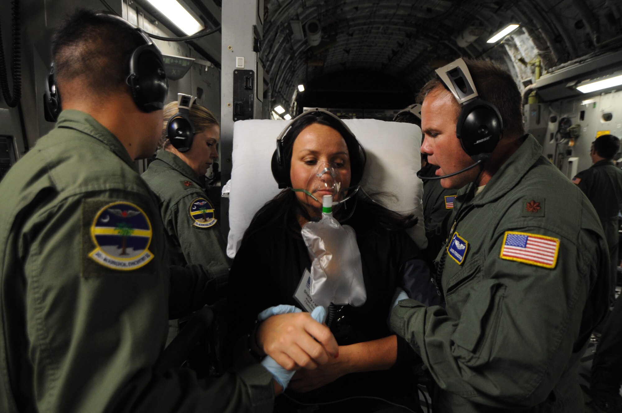 Members of the 315th Aeromedical Evacuation Squadron at Joint Base Charleston, S.C. utilize their medical skills on Sherry Perkins during a 315 AES Squadron training flight to Keesler Air Force Base, Miss. June 21, 2012. The flight introduced Perkins, and other Guard and Reserve employers, to the U.S. Air Force Reserve and allowed them to see what their employees do when they report for training and participate in real-world missions. Perkins is a clinical manager at one of the Roper St. Francis Healthcare emergency departments in Charleston, S.C. (U.S. Air Force Photo/Staff Sgt. Shane Ellis)