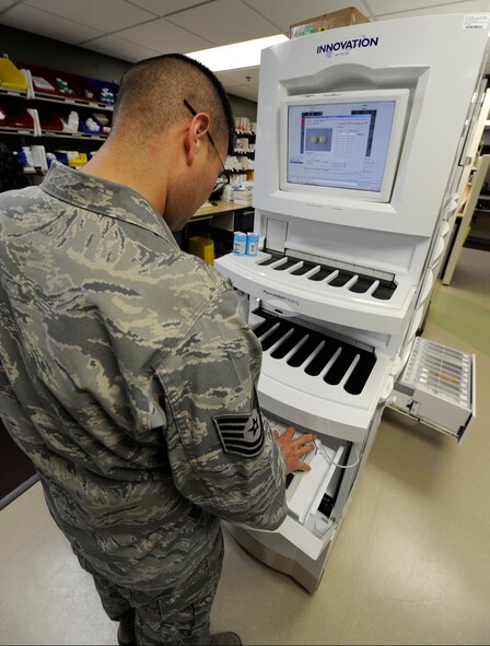Tech Sgt. Michael Payne, 92nd Medical Support Squadron NCO in charge of the refill pharmacy, operates the PharmASSIST Robot X in the pharmacy at Fairchild Air Force Base, Wash., June 7, 2012. The “robot” is a machine that holds approximately 200 different prescriptions and when programmed will automatically fill them. (U.S. Air Force photo by Airman 1st Class Ryan Zeski/Released)