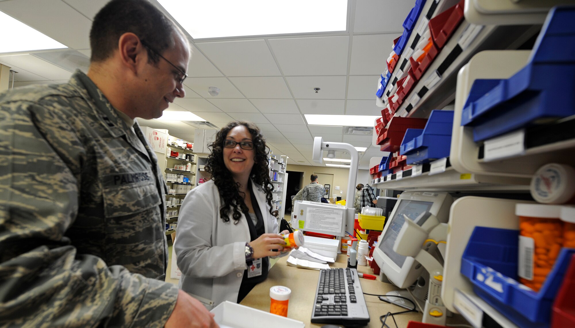 Capt. Gregory Palmrose, 92nd Medical Support Squadron ambulatory care pharmacist, and Lora Nayebpour, Washington State University student pharmacist, fill prescriptions in the medical center at Fairchild Air Force Base, Wash., June 7, 2012. The base pharmacy fills on average 700 prescriptions per day. (U.S. Air Force photo by Airman 1st Class Ryan Zeski/Released)