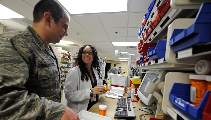 Capt. Gregory Palmrose, 92nd Medical Support Squadron ambulatory care pharmacist, and Lora Nayebpour, Washington State University student pharmacist, fill prescriptions in the medical center at Fairchild Air Force Base, Wash., June 7, 2012. The base pharmacy fills on average 700 prescriptions per day. (U.S. Air Force photo by Airman 1st Class Ryan Zeski/Released)