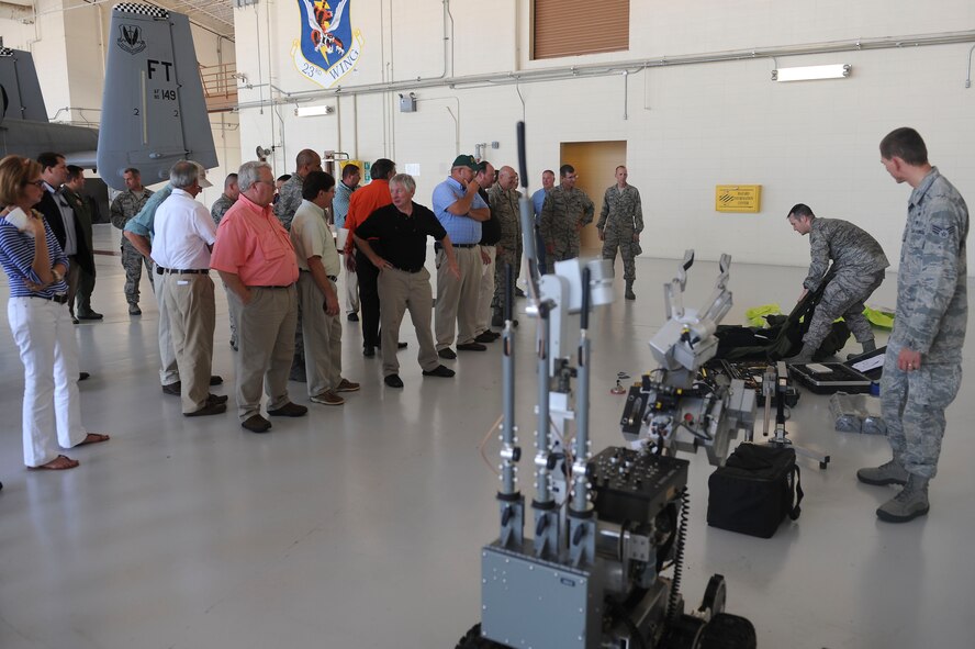 U.S. Air Force Airmen from the 23d Civil Engineer Squadron explosive ordnance disposal flight explain their equipment to Moody honorary commanders for immersion day at Moody Air Force Base, Ga., June 29, 2012. During the day, the visitors got the chance to spend time with their sponsoring unit leaders, eat lunch with Airmen and attend a promotion ceremony. (U.S. Air Force photo by Staff Sgt. Ciara Wymbs/Released)