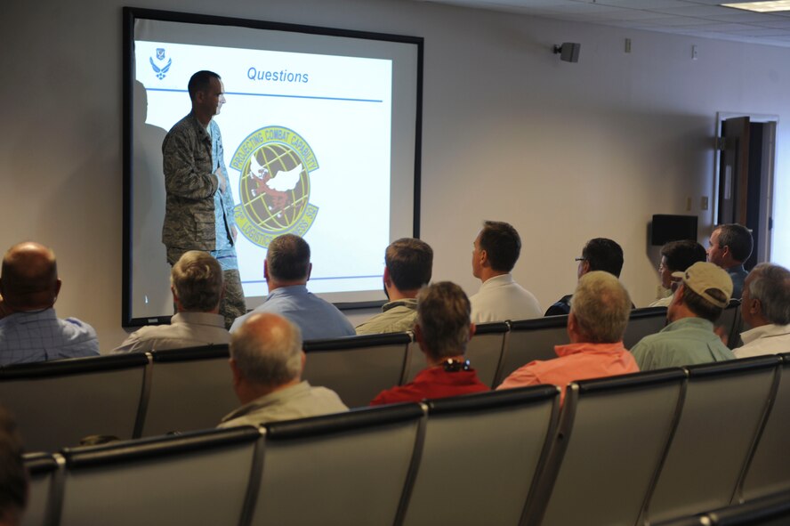 U.S. Air Force Lt. Col. Joseph Rodriguez, 23d Logistics Readiness Squadron commander, explains the meaning behind the squadron patch to Moody honorary commanders at Moody Air Force Base, Ga., June 29, 2012. The honorary commanders visited as part of immersion day, where they toured the base and learned about the Moody mission. (U.S. Air Force photo by Staff Sgt. Ciara Wymbs/Released)