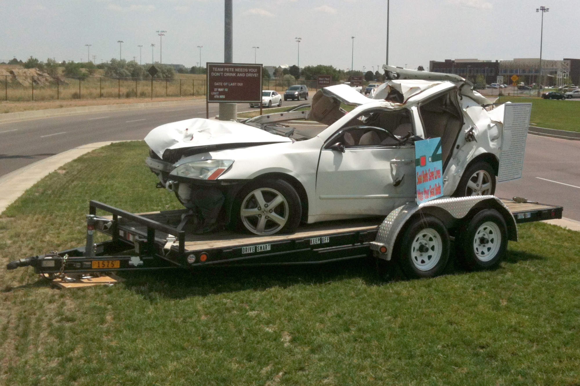 PETERSON AIR FORCE BASE, Colo. - A crashed car is on display at the west gate as part of the Critical Days of Summer campaign. The display is an actual car from a drunk driving accident on loan from Drive Smart Colorado Springs. The purpose of the display is to remind Airmen about the hazards of drinking and driving and the importance of always wearing a seatbelt. (U.S. Air Force photo/Staff Sgt. Trinity Bolman)
