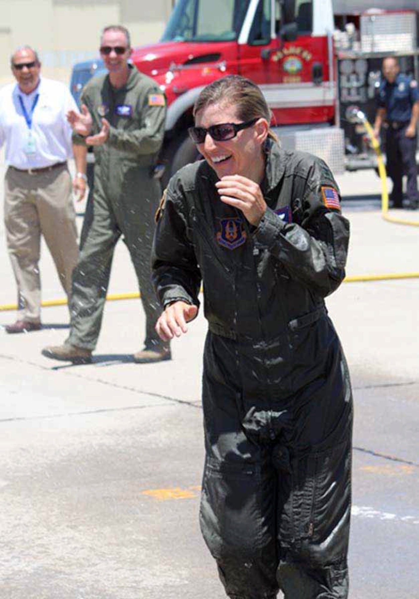 Col. Mary Aldrian received the customary “hose down” by family members as she officially ended her end-of-tour fini flight at March Air Reserve Base, Calif., June 14. (U.S. Air Force courtesy photo) 