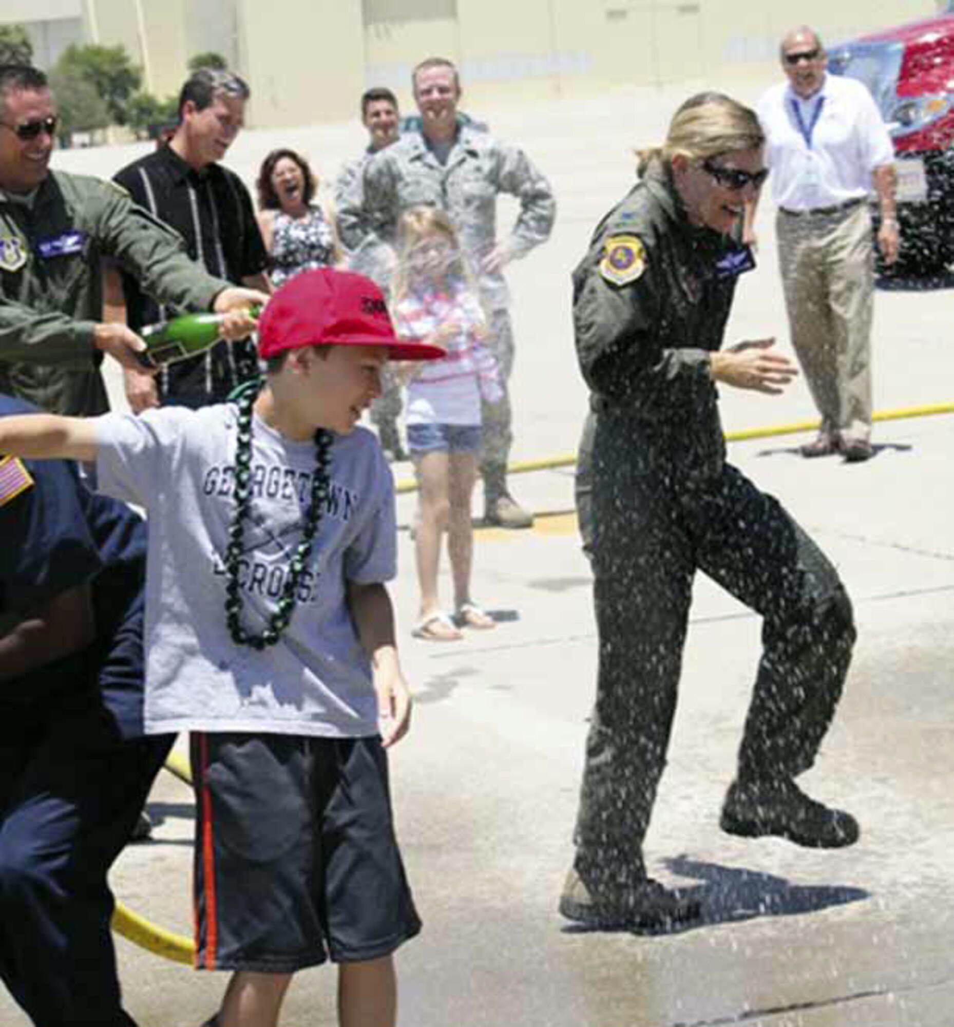 Col. Mary Aldrian received the customary “hose down” by family members as she officially ended her end-of-tour fini flight at March Air Reserve Base, Calif., June 14. (U.S. Air Force courtesy photo) 
