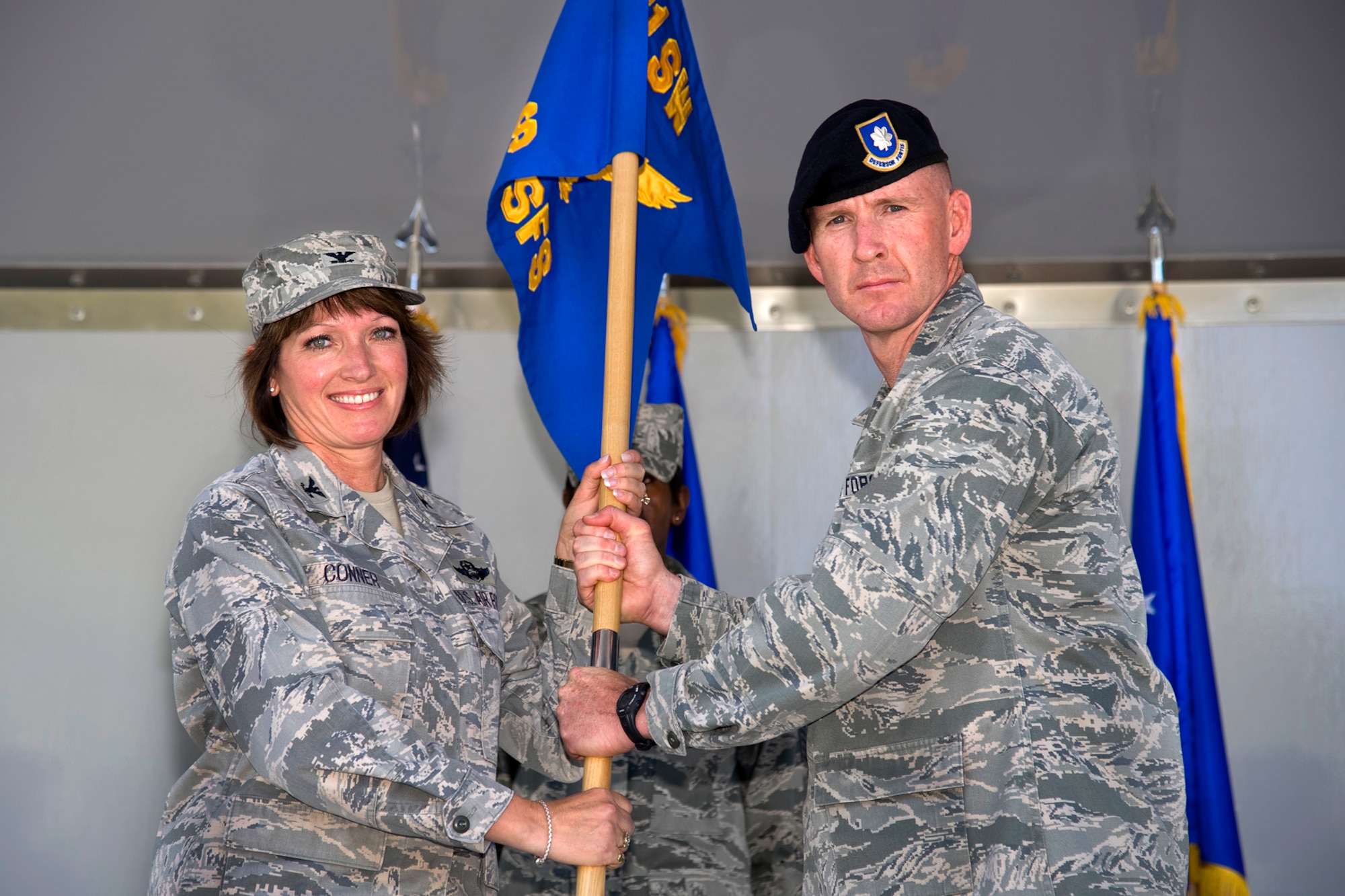 PETERSON AIR FORCE BASE, Colo. – Lt. Col. Sean Tiernan accepts the 21st Security Forces Squadron flag from Col. Kimerlee Conner, 21st Mission Support Group commander, and assumes command of the 21st SFS June 25, 2012. Tiernan comes to Peterson AFB from Air Force Central Command at Shaw Air Force Base, S.C. The 21st SFS maintains the second-largest working dog kennel in the United States and deploys combat-ready Airmen worldwide. (U.S. Air Force photo/Craig Denton)