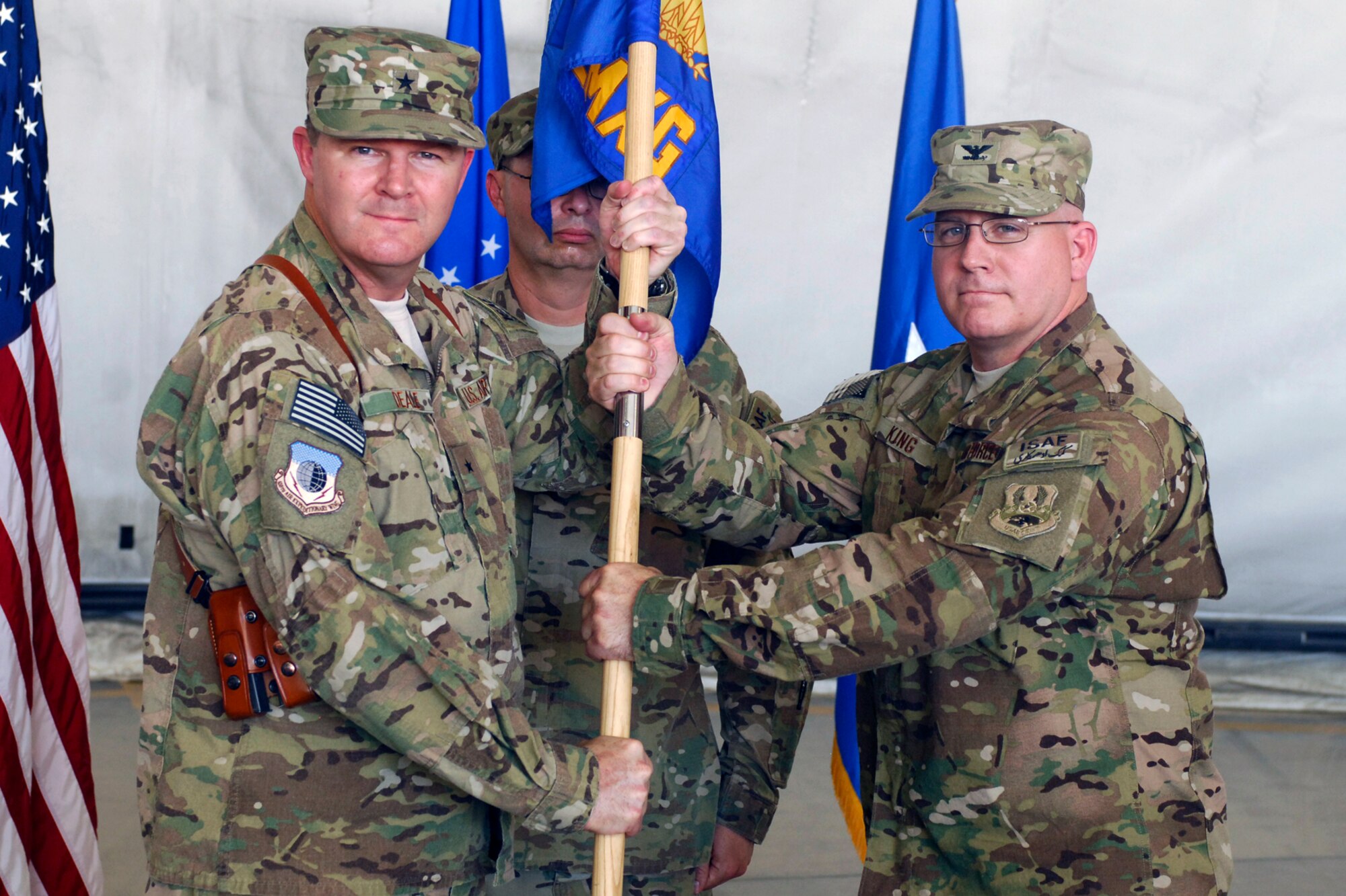 Brig. Gen. Thomas Deale (left), 455th Air Expeditionary Wing commander, presents the guidon to Col. Jeffrey King as he assumes command of the 455th Expeditionary Maintenance Group at Bagram Airfield, Afghanistan, July 2, 2012. Colonel King is a career maintenance officer and has deployed in support of Operations Southern Watch, Northern Watch, Iraqi Freedom and Enduring Freedom. (U.S. Air Force photo/Staff Sgt. Jeff Nevison)