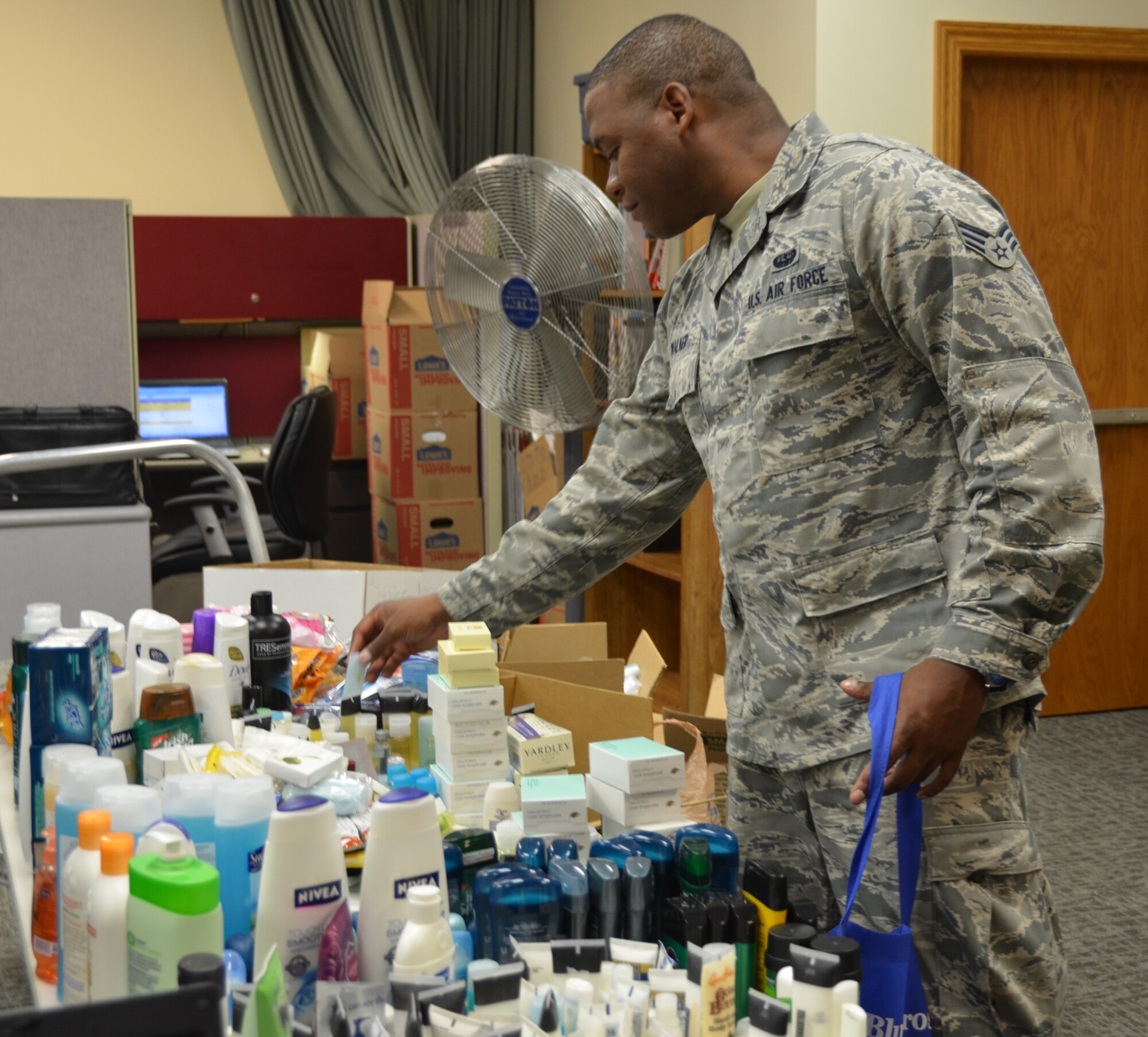 WRIGHT-PATTERSON AIR FORCE BASE, Ohio – 445th Airlift Wing Airman’s Council member Senior Airman Joshua Walker, 445th Airlift Wing orderly room knowledge operations management apprentice, helps fellow Airman’s Council members build comfort kits for Dayton Veterans Affairs Medical Center residents May 31. The Airman’s Council built and delivered 180 comfort kits for the residents with each kit containing 20 toiletry items. (U.S. Air Force photo/Stacy Vaughn)