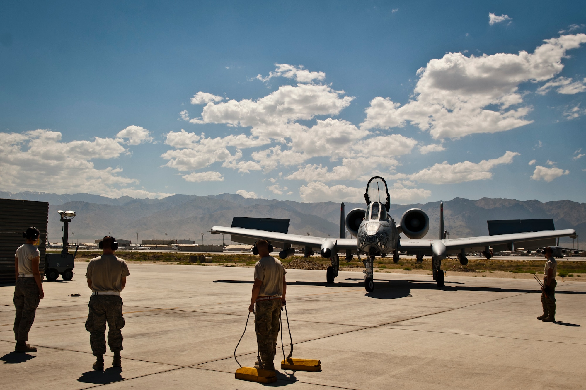 Airmen from the 455th Expeditionary Aircraft Maintenance Squadron prepare to receive a U.S. Air Force A-10 Thunderbolt II after a mission at Bagram Airfield, Afghanistan, June 30, 2012. The 455th Air Expeditionary Wing is responsible for providing responsive and precise close-air support to NATO and Afghan ground forces operating in Afghanistan. (U.S. Air Force photo/Capt. Raymond Geoffroy)