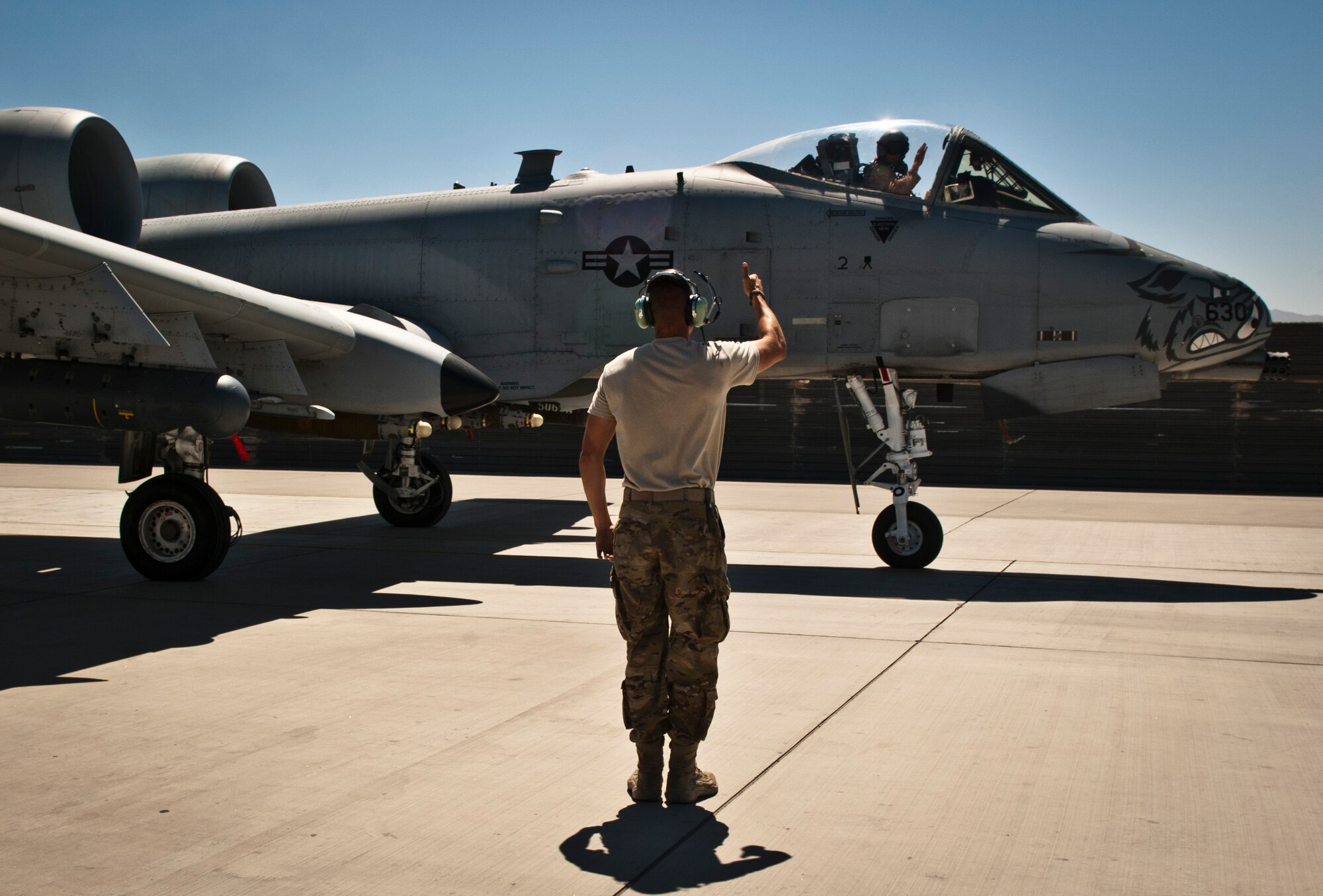 An Airman from the 455th Expeditionary Aircraft Maintenance Squadron marshals U.S. Air Force A-10 Thunderbolt II before a mission at Bagram Airfield, Afghanistan, June 30, 2012. Bagram’s A-10s fly daily to provide constant close-air support to NATO and Afghan ground forces operating in Afghanistan.  (U.S. Air Force photo/Capt. Raymond Geoffroy)