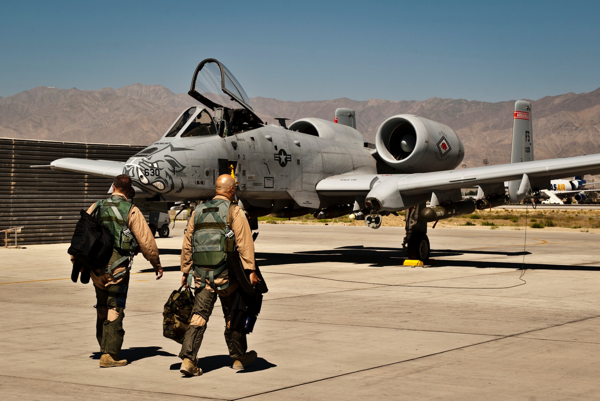 Pilots from the 455th Air Expeditionary Wing walk to a U.S. Air Force A-10 Thunderbolt II before a mission at Bagram Airfield, Afghanistan, June 30, 2012. The 455th AEW is responsible for providing responsive and precise close-air support to NATO and Afghan ground forces operating in Afghanistan. (U.S. Air Force photo/Capt. Raymond Geoffroy)