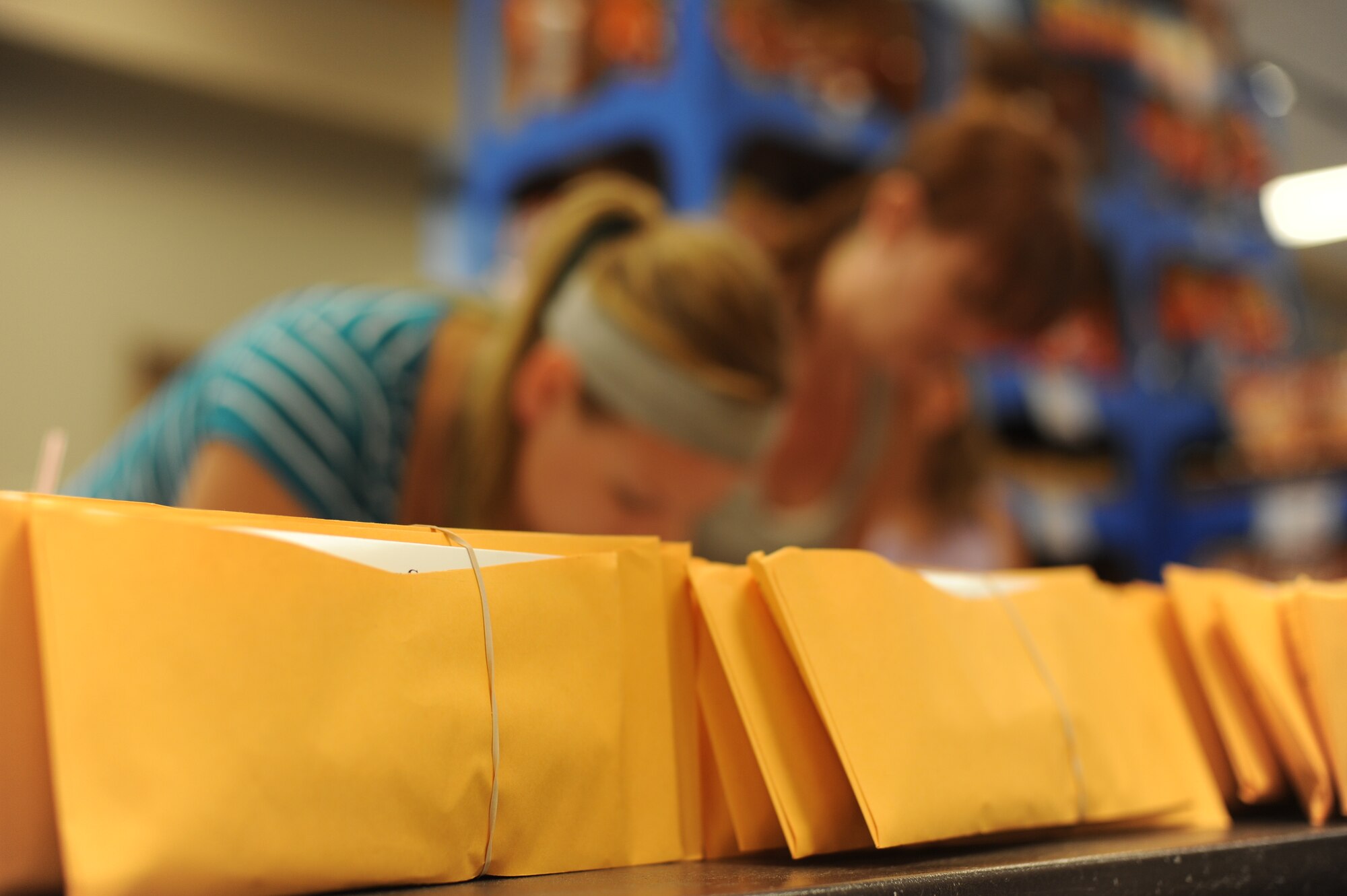 Commissary patrons fill out registration forms for the C.W. Bill Young Department of Defense Marrow Donor Program during a drive at the base commissary at Hurlburt Field, Fla., June 27, 2012. Organizers from Detachment 3, 342nd Training Squadron coordinated with drive as a means to heighten awareness and recruit potential donors to save lives. (U.S. Air Force photo / Airman 1st Class Naomi Griego)(Released)