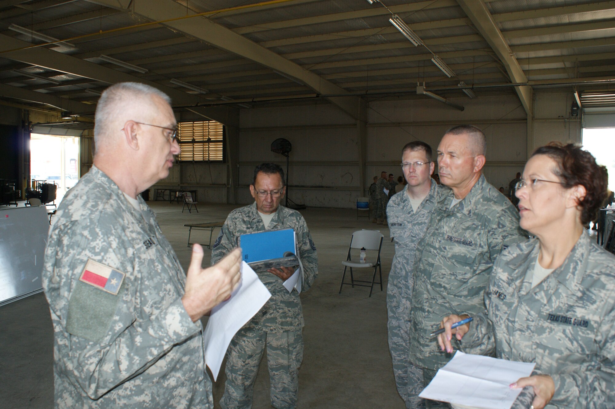 Col. Frank Stead, Deputy J-3 TXSG HQ (left), discusses shelter managment procedures with (right to left) Airman 1st Class Carolyn James, Senior Airman Randy Willis, Senior Airman Spencer Hauenstein and Master Sgt. Jesse Doria  Jun. 29, 2012 at Camp Bowie Training Center in Brownwood, Texas.  The Air Component Command is at Camp Bowie for the Texas State Guard's 2012 annual training.    (Texas State Guard photo/SMSgt Dan Hawkins)