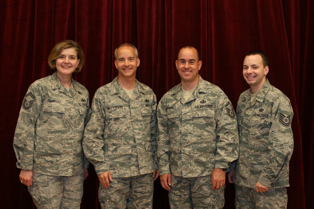 Four of The United States Air Force Band's recent promotion selectees. From left:  Senior Master Sgt. Jenn Pagnard, Master Sgt. Phil Krzywicki, Master Sgt. Bob Kamholz and Technical Sgt. Frank Busso.  (U.S. Air Force photo by Master Sgt. Tara Islas)