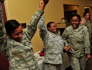 MINOT AIR FORCE BASE, N.D. -- Staff Sgt. Ashley Sakurai, Senior Airman Antona Gaskins, both from the 741st Missile Squadron and SrA Qushondra Owens, 721 Missile Squadron, celebrate their victory against the 5th Bomb Wing chefs, here June 27. The annual competition gave Team Minot chefs the chance to demonstrate their skills and be recognized for their talents in a friendly environment. It was a true test of culinary mastery as a team from each wing went head-to-head in a 45-minute, ultimate dish showdown. (U.S. Air Force photo/Senior Airman Desiree W. Esposito)
