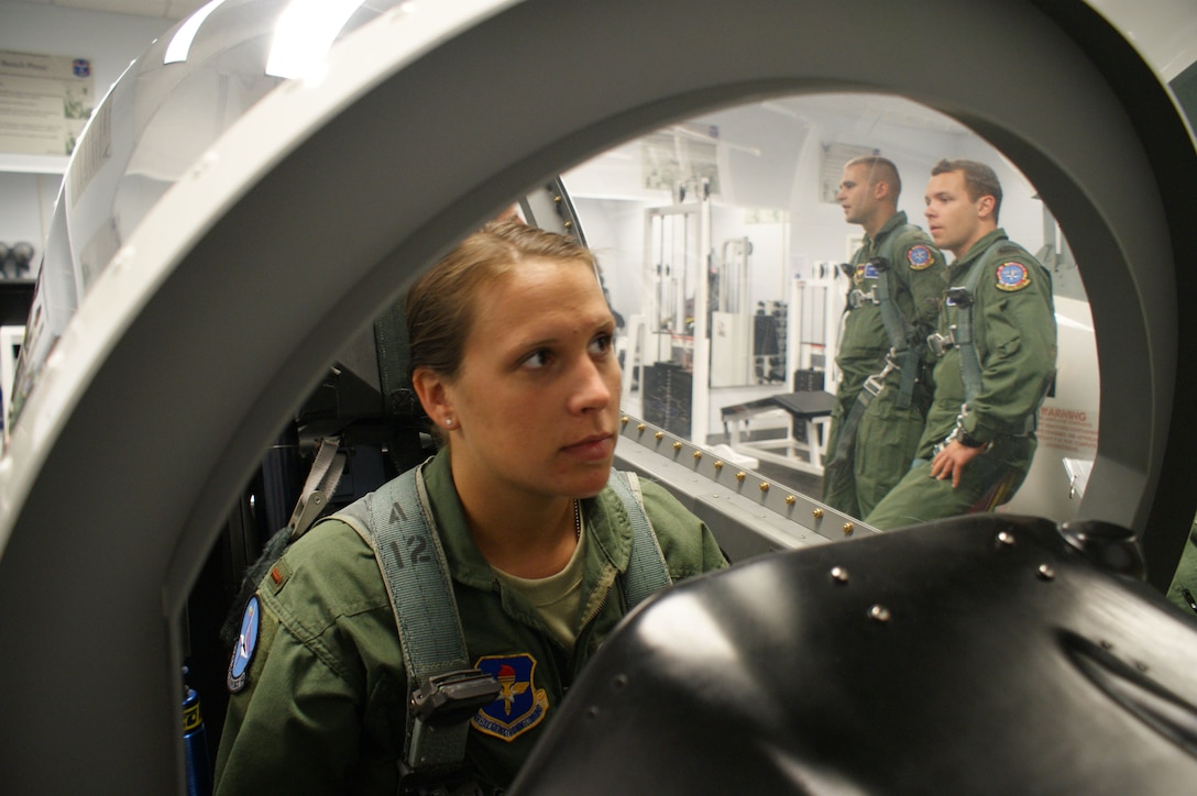 2nd. Lt. Shanon Davis, student in the Euro-NATO Joint Jet Pilot training program, listens to egress instructions while seated in a T-6 Texan mock cockpit during training Jun 13, 2012 at Sheppard Air Force Base, Texas.  Egress training is part of the physiological training curriculum taught by the 82nd Aerospace Medicine Squadron. (U.S. Air Force photo/Dan Hawkins)