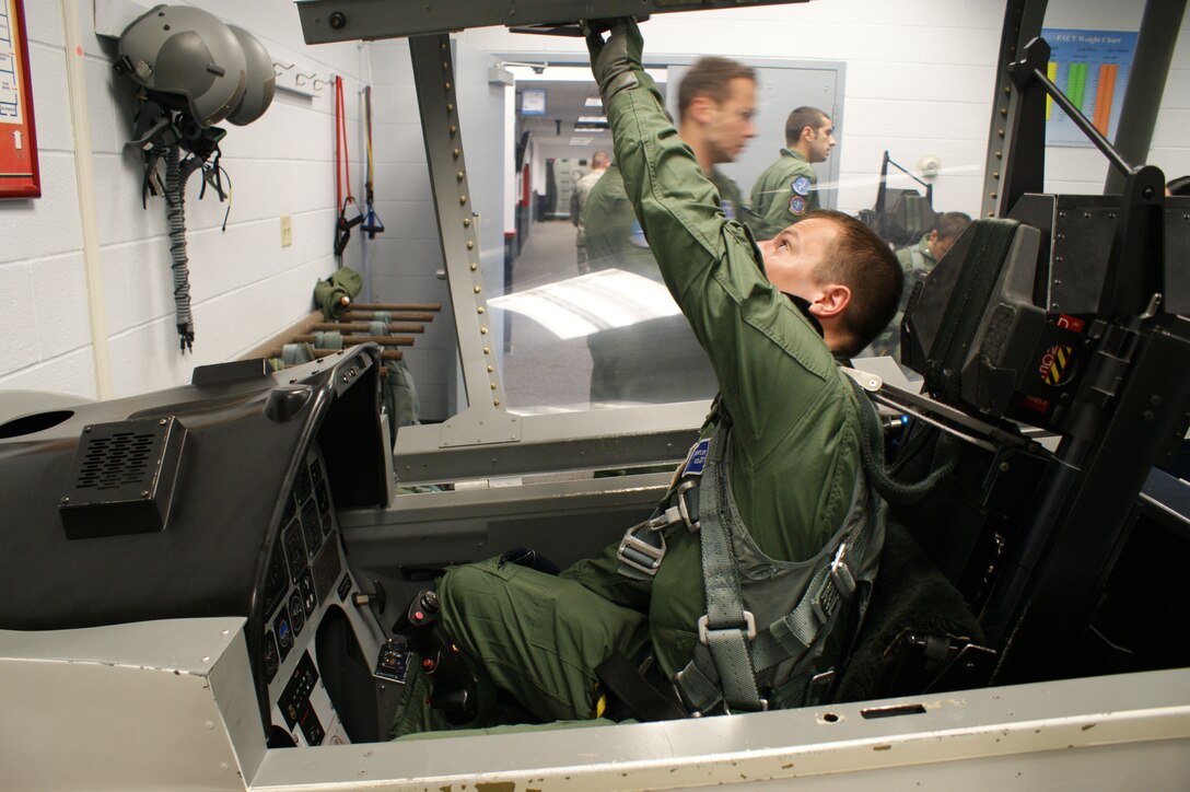1st. Lt. Noah Spitler, student in Euro-NATO Joint Jet Pilot training program, prepares for egress training in a T-6 Texas mock cockpit Jun 13, 2012 at Sheppard Air Force Base, Texas.  The egress training is part of the 50 hours of physiological training pilots receive in their first year of pilot training.  (U.S. Air Force photo/Dan Hawkins)