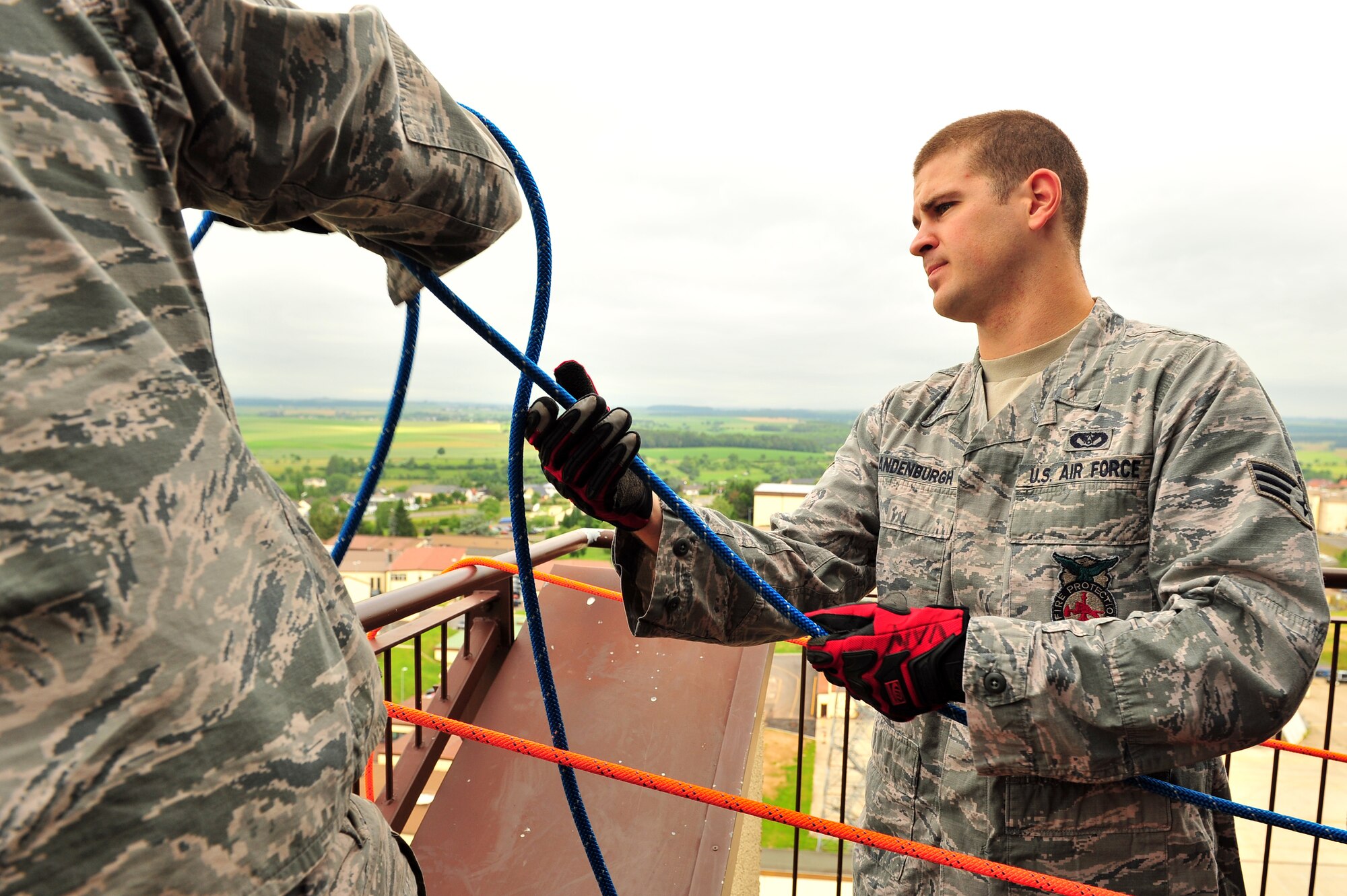 SPANGDAHLEM AIR BASE, Germany -- Senior Airman Steven Vandenburgh, 52nd Civil Engineer Squadron firefighter, pulls up a rope with rappelling equipment attached during training at the control tower here June 29. Firefighters from the 52nd CES complete rappelling training so they can be rescue certified to perform rope and high-angle rescue techniques. The firefighters train annually to ensure the force maintains the highest level of proficiency and readiness for rapid rescue attempts in demanding situations. (U.S. Air Force photo by Airman 1st Class Dillon Davis/Released)