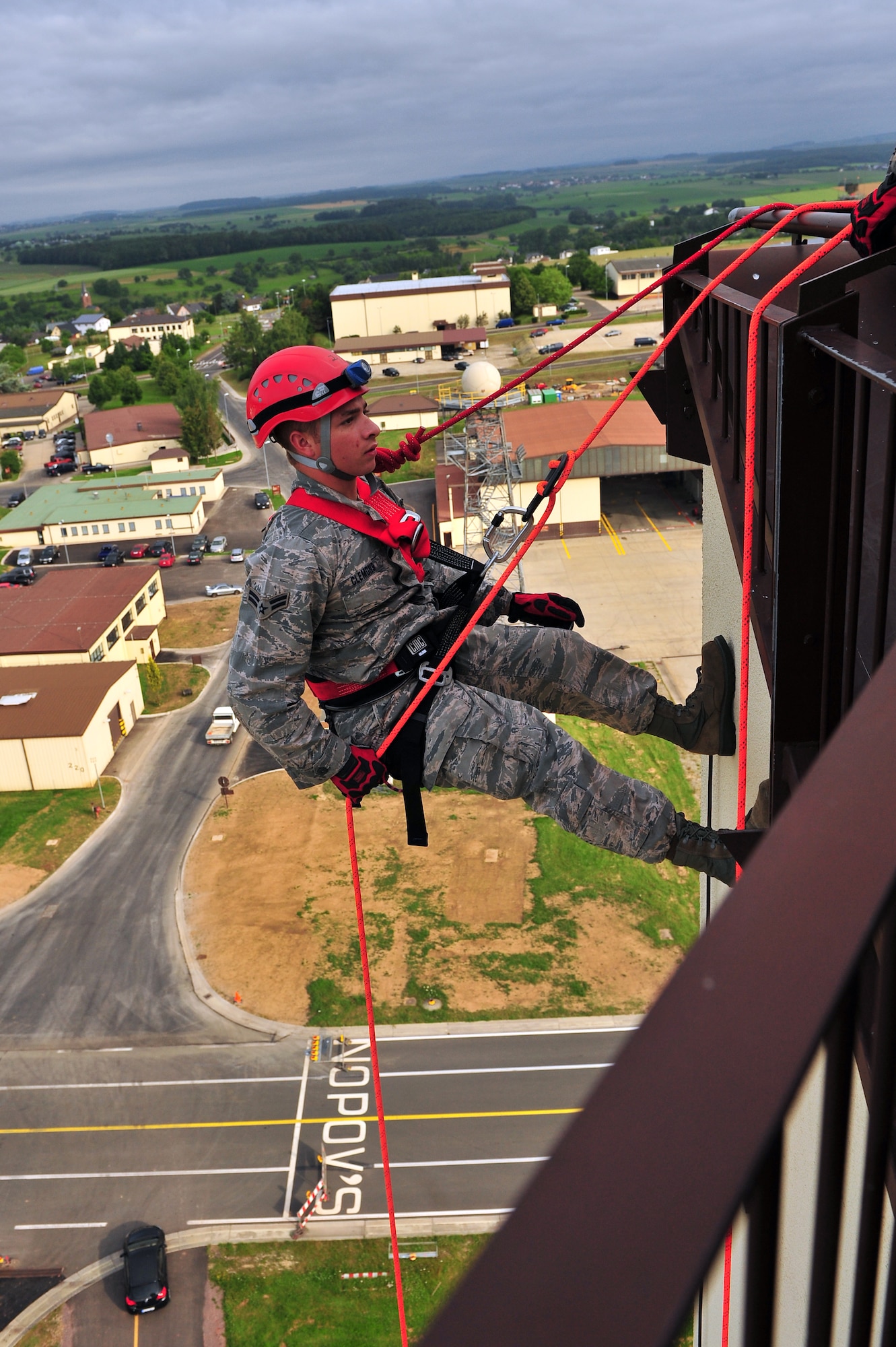 SPANGDAHLEM AIR BASE, Germany – Airman 1st Class Tyler Clemons, 52nd Civil Engineer Squadron firefighter, rappels down the control tower during training here June 29. Firefighters from the 52nd CES complete rappelling training so they can be rescue certified to perform rope and high-angle rescue techniques. The firefighters train annually to ensure the force maintains the highest level of proficiency and readiness for rapid rescue attempts in demanding situations. (U.S. Air Force photo by Airman 1st Class Dillon Davis/Released)