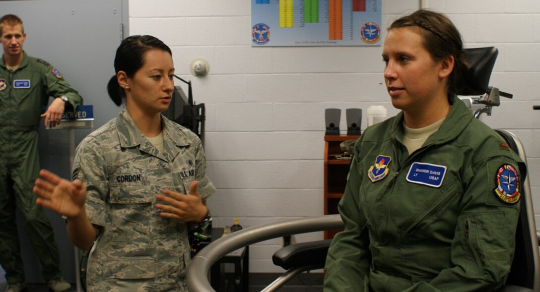 Senior Airman Katia (left), 82nd Aerospace Medicine Squadron aerospace and operational physiology specialist, explains the dynamics of the Barany Chair to Euro-NATO Joint Jet Pilot Training program student 2nd Lt. Shanon Davis during physiology training at Sheppard Air Force Base, Texas,  Jun 8, 2012.  The Barany Chair simulates spacial disorientation pilots would be exposed to during actual flight.  (U.S. Air Force photo/Dan Hawkins)